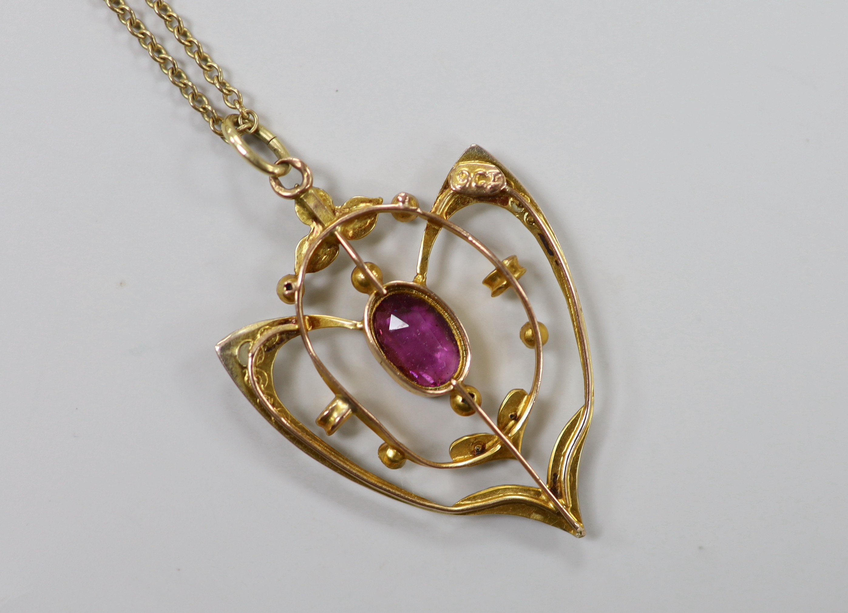 An Edwardian 9ct, garnet and seed pearl cluster set pendant, 33mm, on a later 9ct chain, 39cm, gross weight 3.7 grams.